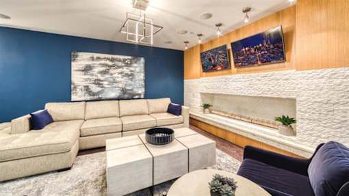 A modern living room with a large sectional sofa and a coffee table.