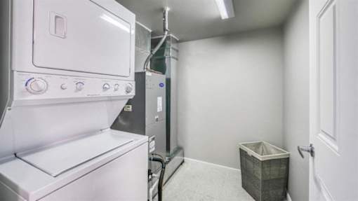A white oven and dryer in a small laundry room.