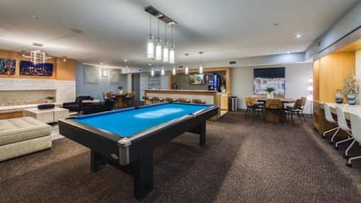 A room with a pool table and a TV.