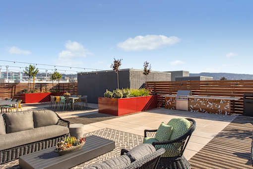 A patio with a table, chairs, and a couch.