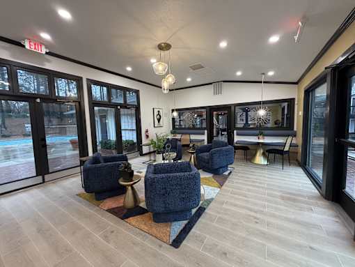 Resident clubhouse at Remington Place Apartments in Raleigh, NC featuring pool views and blue seating area