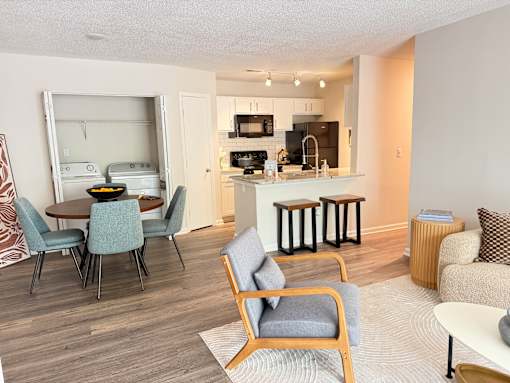 A modern kitchen with a dining table and chairs.