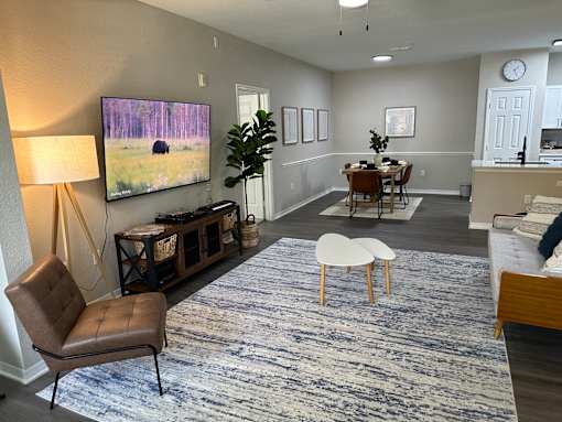 A living room with a brown leather chair and a blue patterned rug.
