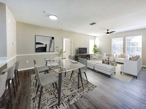 A modern dining room with a glass table and chairs.
