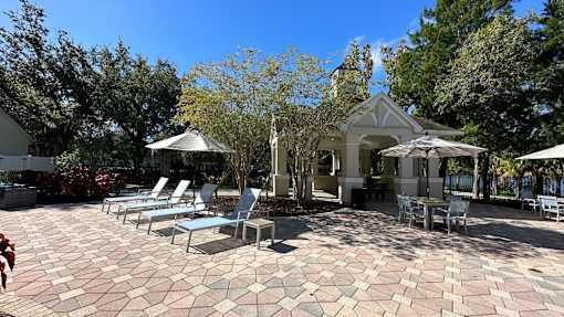 A patio with a table and chairs and a gazebo.