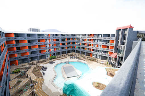 A large outdoor pool surrounded by a building.
