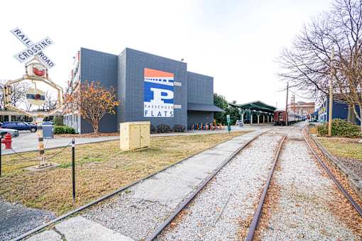 A railroad track with a sign that says "PASSENGER FLATS" on the side of it.