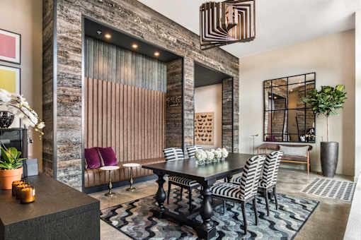 A dining room with a table set for four.
