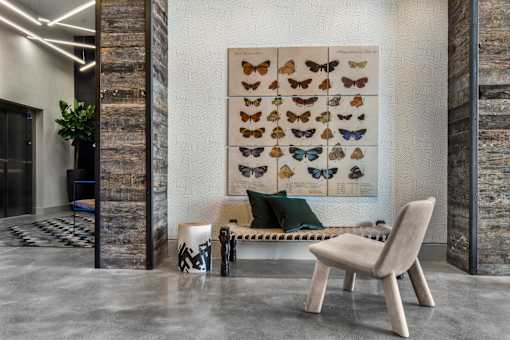 A modern living room with a large poster of butterflies on the wall.