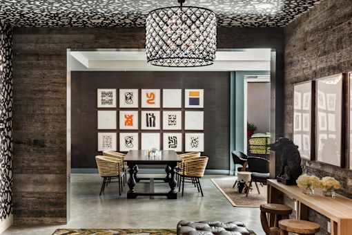 A modern dining room with a wooden table and chairs.