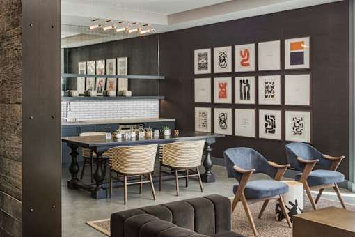 A modern dining room with a long table and chairs.