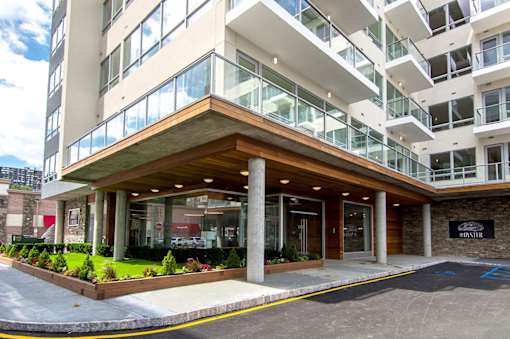 A modern building with a brown entrance and glass windows.