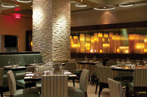 A restaurant with tables and chairs set for dining.