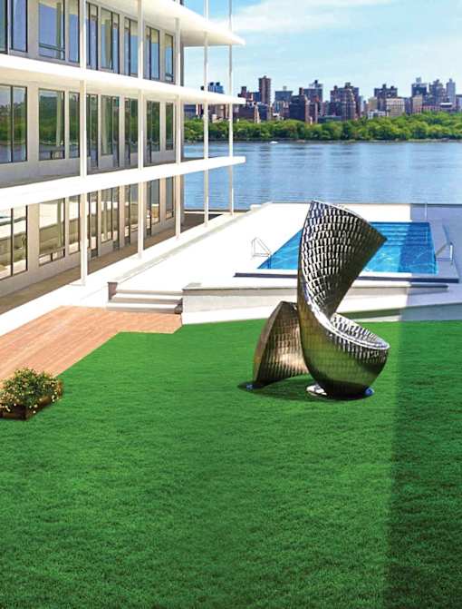 A modern chair is placed on a green lawn.