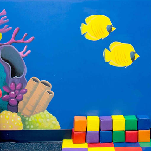 Three yellow fish are swimming in the air above a rainbow of blocks.