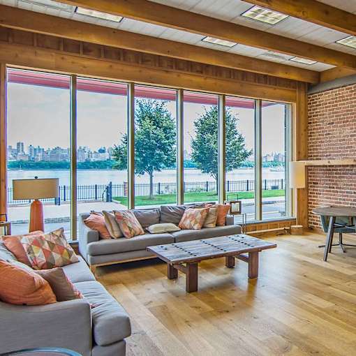 A living room with a grey couch and a wooden coffee table.