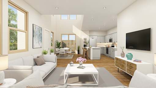 A modern living room with a white sofa and a coffee table in the center.