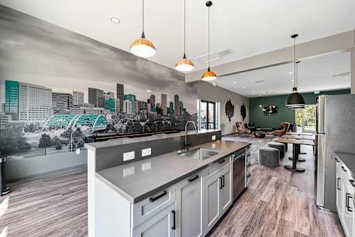 A modern kitchen with a cityscape mural on the wall.