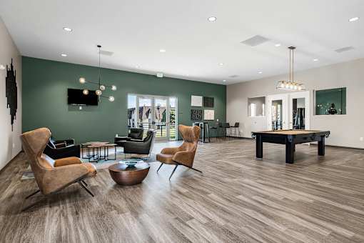 A living room with a wooden floor and a green wall.