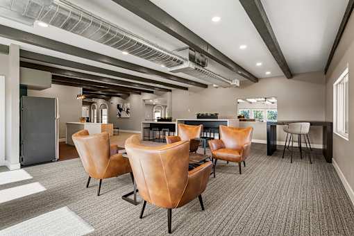 A conference room with brown leather chairs and a grey carpet.