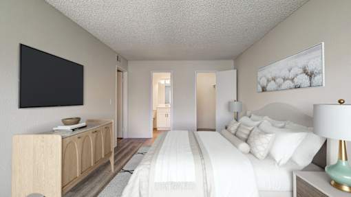 A bedroom with a large bed, a wooden cabinet, and a painting on the wall.