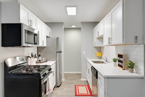 Stratford Wood Apartments and Townhomes in Minnetonka, MN Photo of kitchen with white cabinets and stainless steel appliances