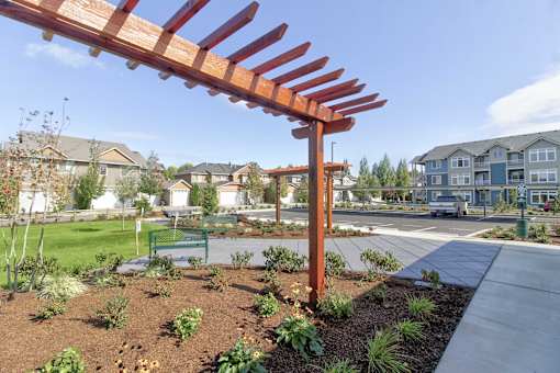A large wooden structure is in the foreground of a residential area.