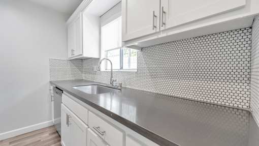 A kitchen with a sink and a window.