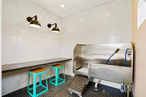 A kitchen with a sink and bar stools.