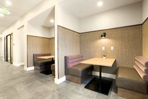 A room with a table and chairs in the middle.