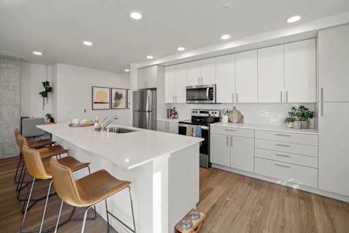 a large white kitchen with a white counter top