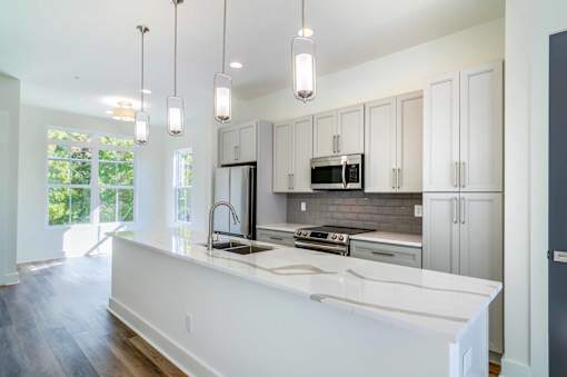 Pet-Friendly Homes In Edgewood, GA – LaFrance Square- A modern kitchen with white countertops and stainless steel appliances.