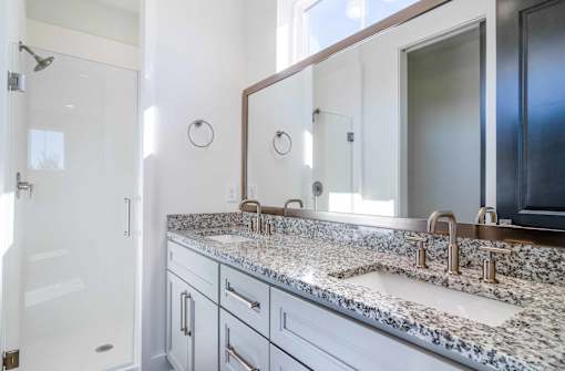 Luxury Homes In Atlanta, GA 30307 for Rent – LaFrance Square – A bathroom with a granite countertop and a large mirror.
