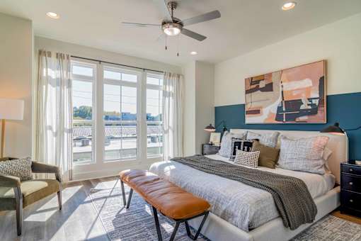 Luxury Atlanta, GA Homes – LaFrance Square – A bedroom with a large bed and a ceiling fan.