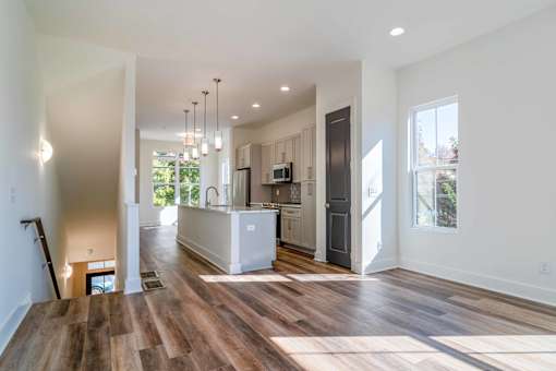 Luxury Homes In Atlanta, GA 30307 for Rent – LaFrance Square – A modern kitchen with wooden floors and a large island.