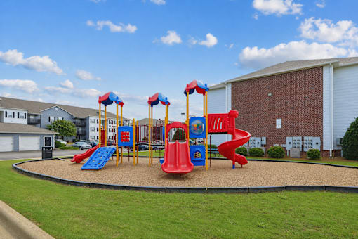 playground at Lancaster Place Apartments in Calera, AL with colorful play equipment and outdoor recreation for families.