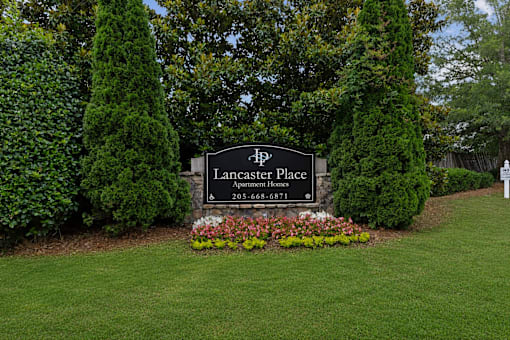 Lancaster Place Apartments entrance monument sign in Calera, Alabama with professionally landscaped grounds welcoming residents in Shelby County near Interstate 65.
