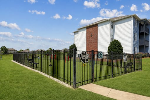 Pet-friendly bark park at Lancaster Place Apartments in Calera, Alabama with fenced play areas and agility equipment for resident pets.