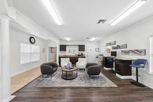 Resident clubhouse lounge at Lancaster Place Apartments in Calera, Alabama with inviting seating and gathering areas for community events.