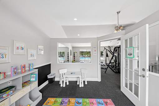 Children's activity room at Lancaster Place Apartments in Calera, AL featuring a colorful play area for younger residents.