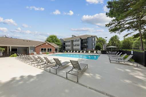Spacious pool deck with lounge seating at Lancaster Place Apartments in Calera, Alabama offering outdoor relaxation and community amenities.