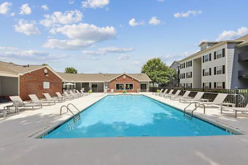 Resort-style swimming pool at Lancaster Place Apartments in Calera, AL with spacious sundeck and lounge seating near Shelby County and I-65.