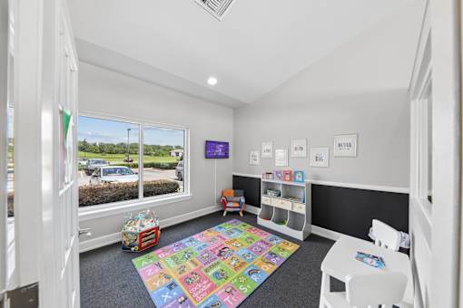 Children's activity room at Lancaster Place Apartments in Calera, AL featuring a colorful play area for younger residents.