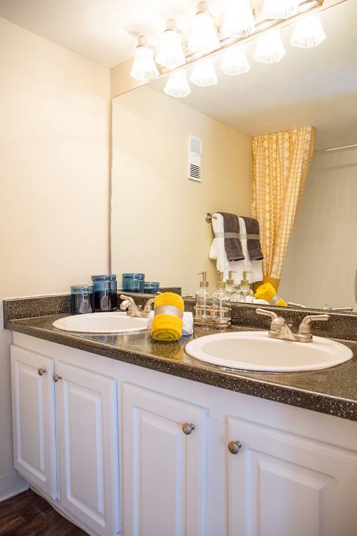 A bathroom with a sink and a mirror.