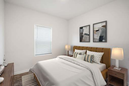A bedroom with a bed, nightstands, and two framed pictures on the wall.