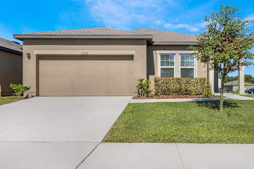 A house with a brown garage door and a driveway.
