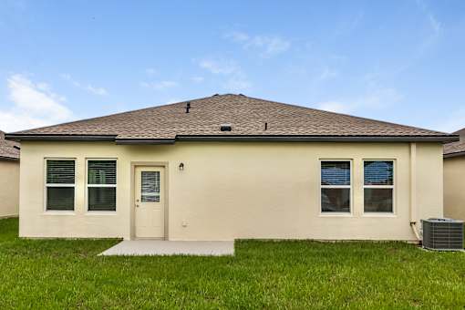 A house with a brown roof and a white door.
