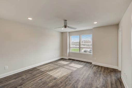 3 BR Townhomes in Gallatin TN - The Gardens at Preston Park - Unfurnished Bedroom with Hardwood Flooring, Window, and Celing Fan