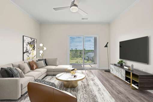 Spacious living room with couch, coffee table, and TV at Hawks Landing Apartments in Hickory, NC