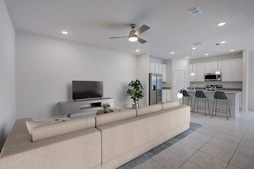 A modern living room with a large couch and a television.